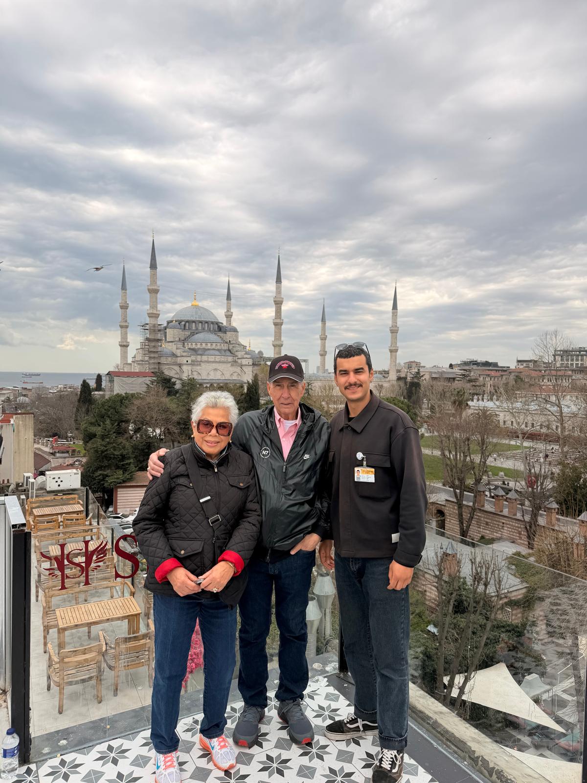 Guests on a rooftop with the Blue Mosque behind